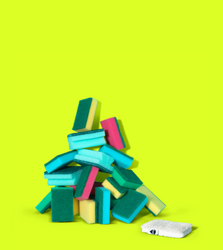 A pile of plastic sponges with one Seep Eco Sponge Scourer laying in front of the pile