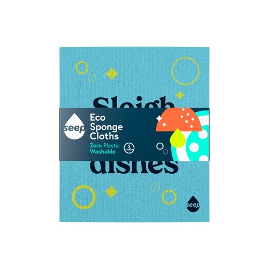 A plastic-free sponge cloth with bubbles, pings and "Sleigh the dishes" slogan printed on it, with a recyclable label around it