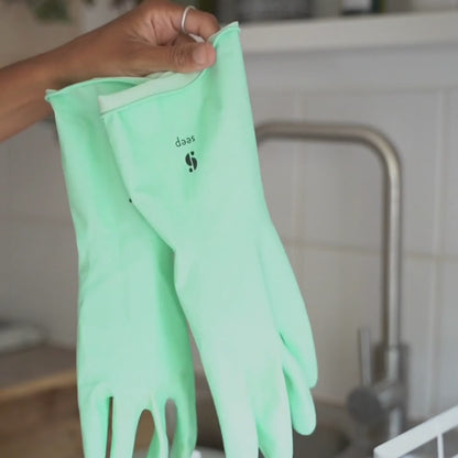 Josephine wearing Seep Turquoise Eco Rubber Gloves in kitchen