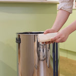 Unrolling of 50 litre biodegradable bin bag and putting it inside a kitchen bin